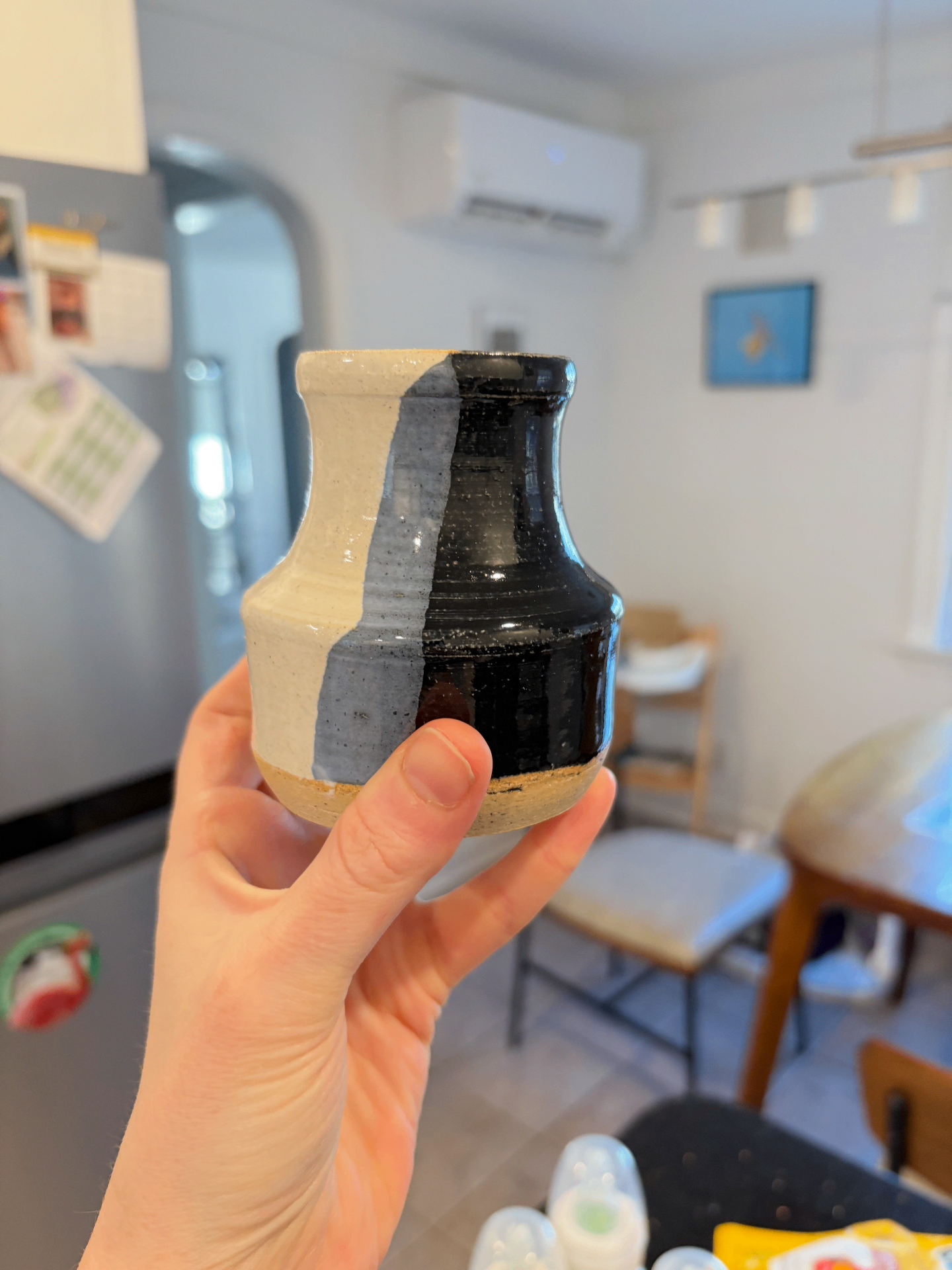 Handcrafted small pottery vase with black and beige glaze